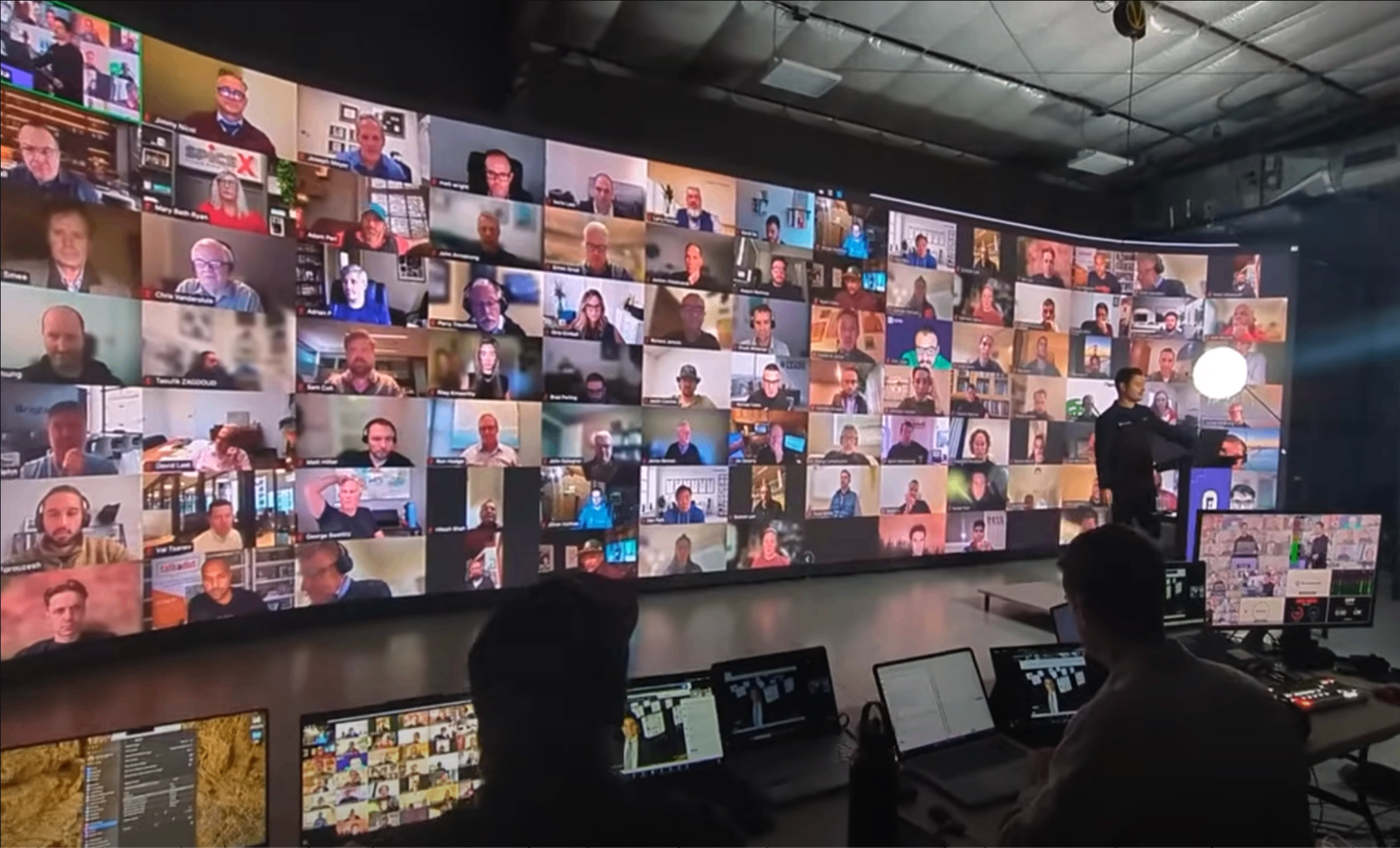 LED panel wall displaying conference participants